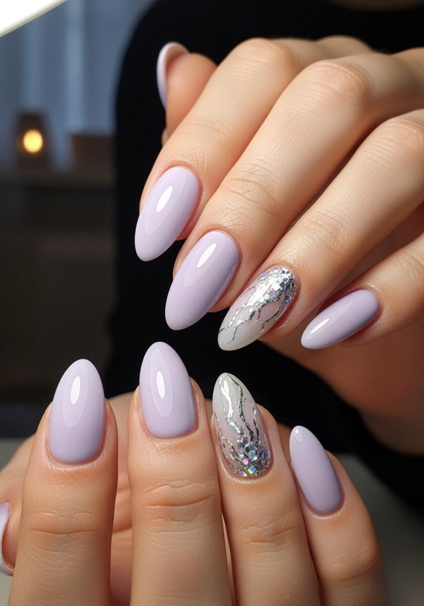 Two hands with almond-shaped lavender nails featuring silver glitter accent nails with swirl designs