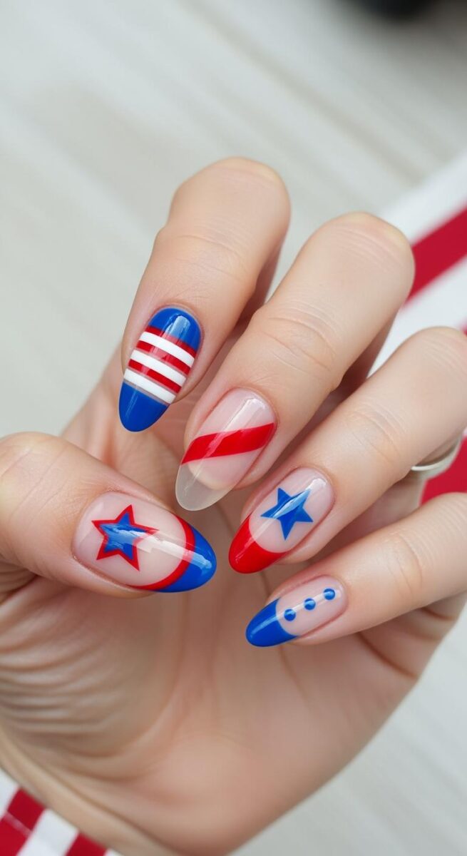 Hand with patriotic red, white, and blue nail art featuring stars and stripes on almond-shaped nails