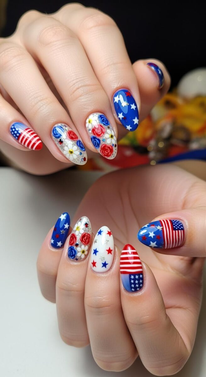 Patriotic red, white, and blue nail art with American flag, stars, stripes, and floral designs on almond-shaped nails