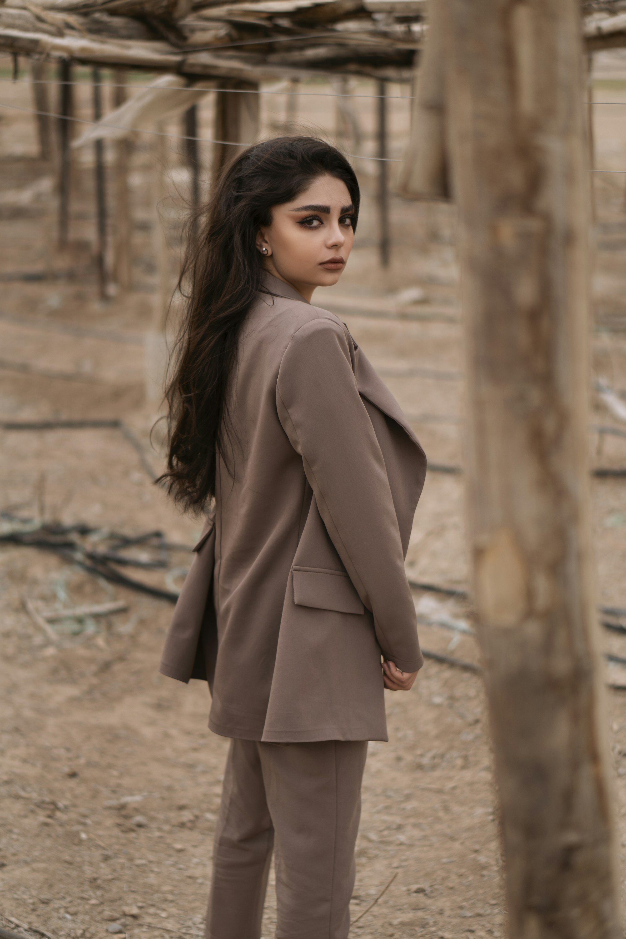 back view of a long mocha blazer and matching trousers